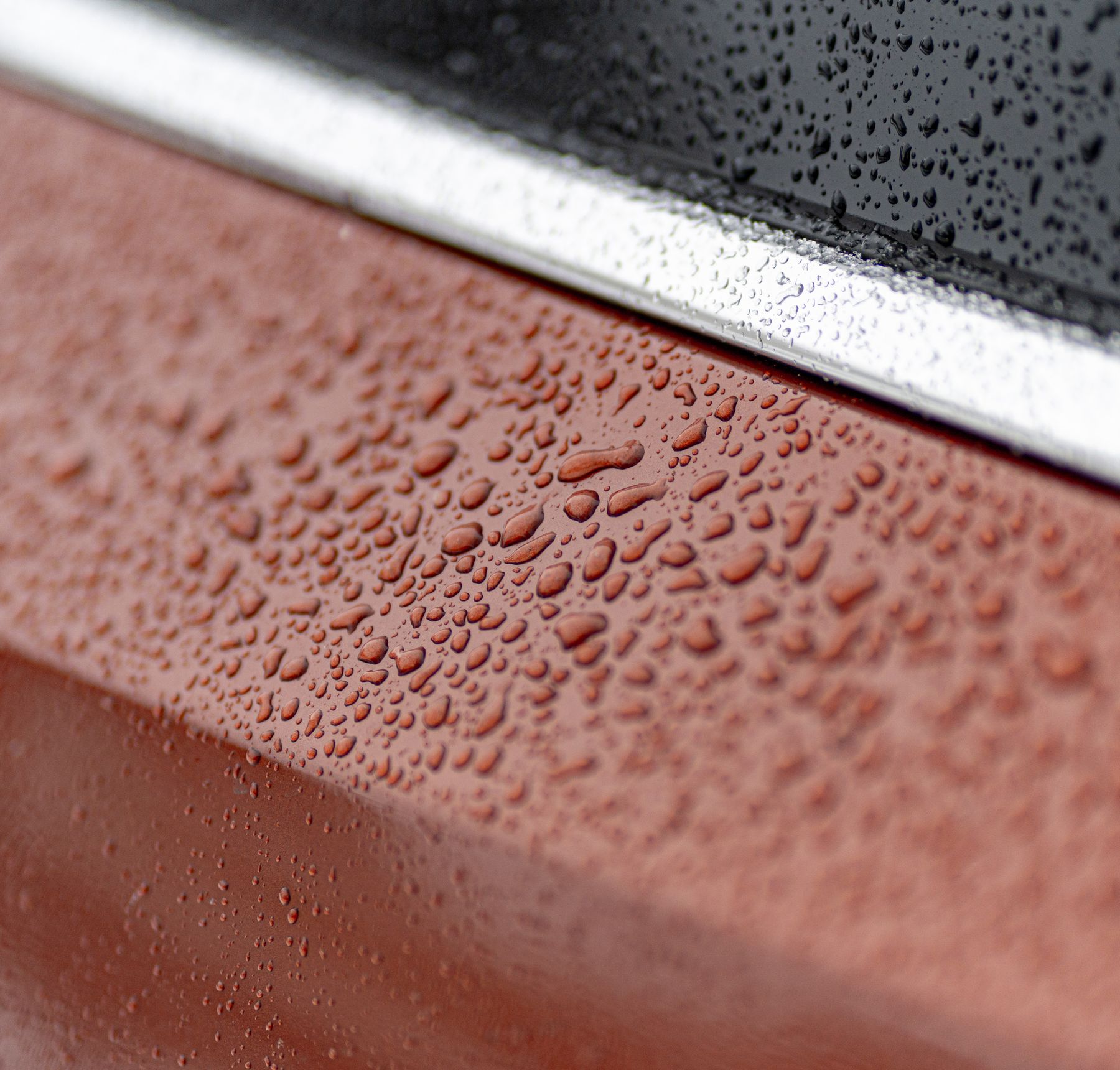 Water beading on red vehicle paint